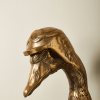 Close-up of a bronze duck sculpture wearing aviator goggles and a helmet, showcasing whimsical and detailed decor available at Urban Goods & Garden in Wilmington, NC.